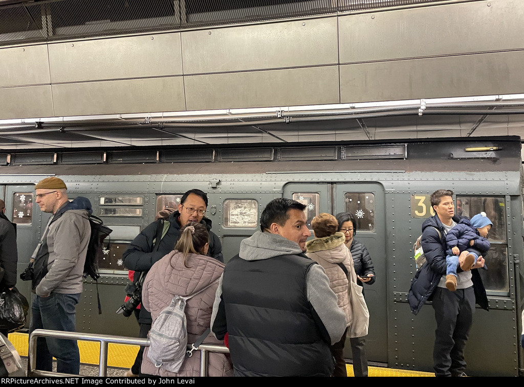 Holiday Train at 96th St while passengers stand in the foreground 